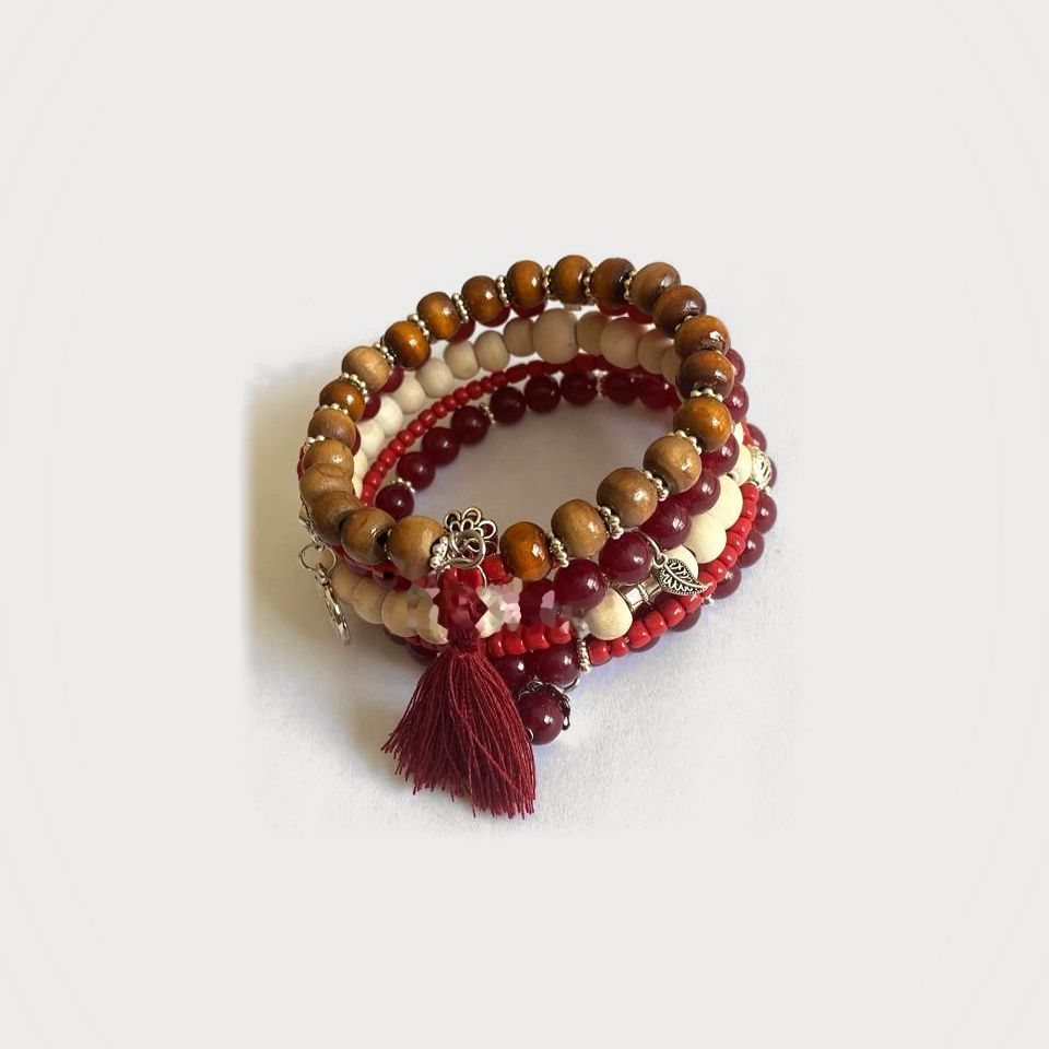 Pulsera Alba en espiral de cuentas de madera y cristal rojo, con borla